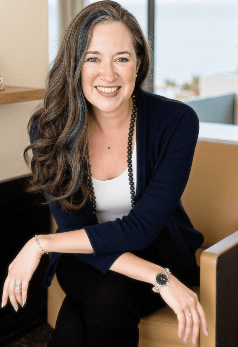 Benah Parker, Ph.D. seated in a black suit and white top with a smiling, confident expression