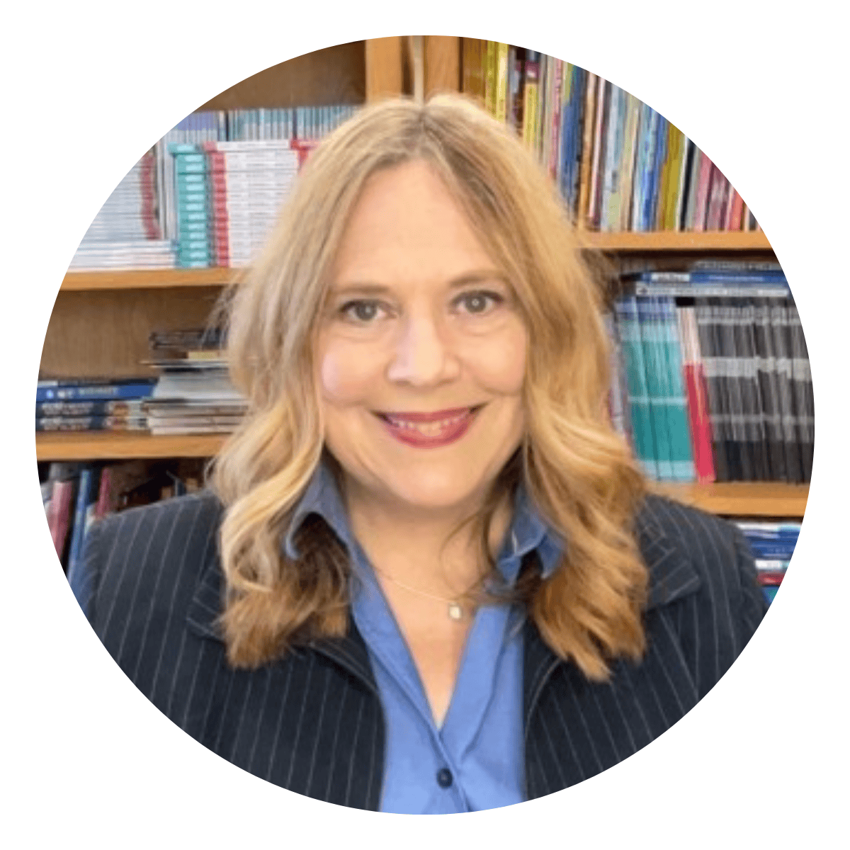 Professional headshot of a female executive coaching client with blond hair in front of book shelves