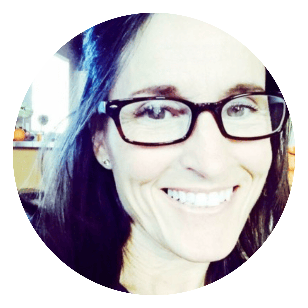 Close up photo of while female executive coaching client smiling broadly, mid-50s