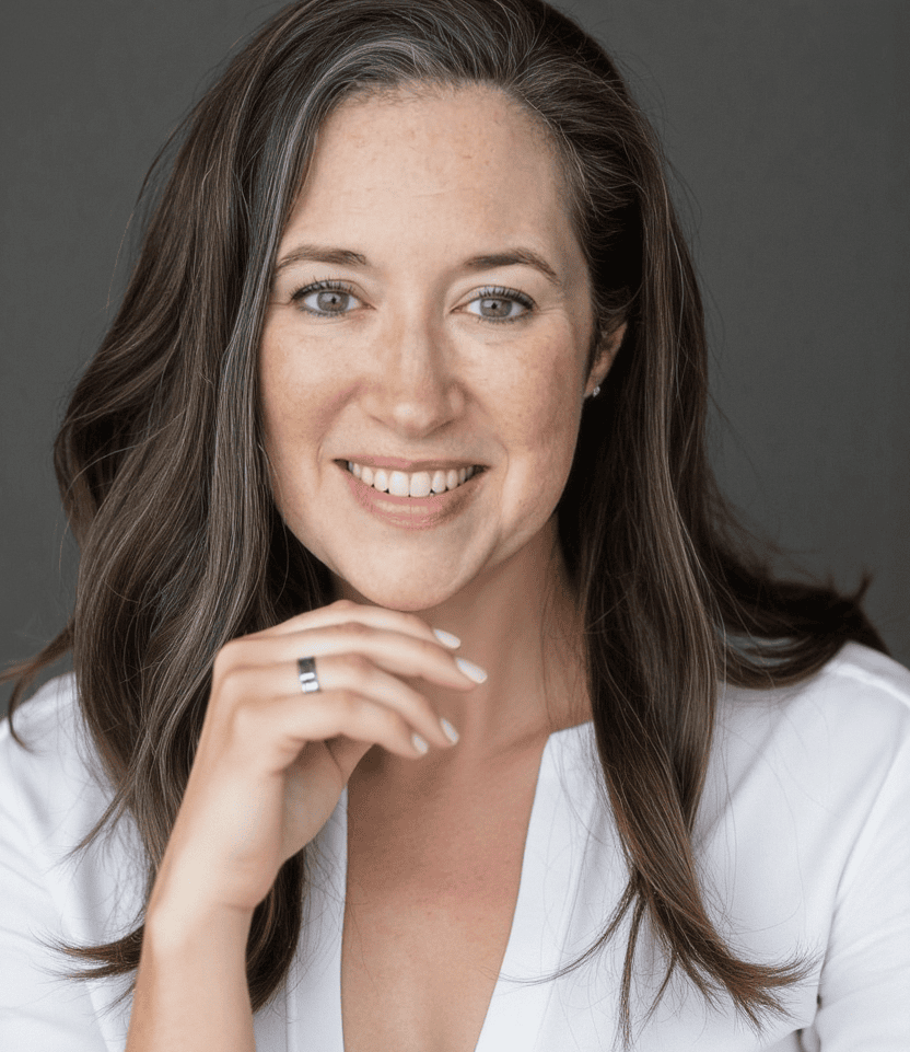 Close-up portrait of Benah Parker, Ph.D. in a white top with a confident expression
